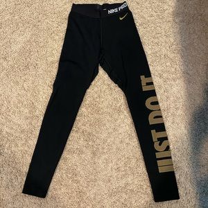 Black and gold Nike Dri-fit workout leggings